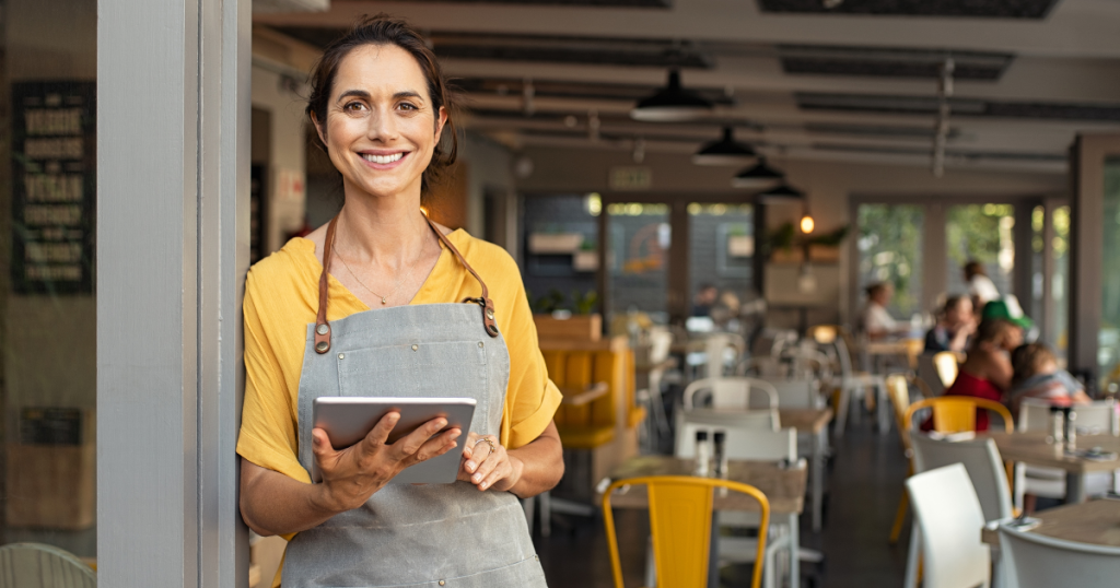 Smiling small business owner in a cafe, showcasing the importance of flexible funding options for bad credit loans.