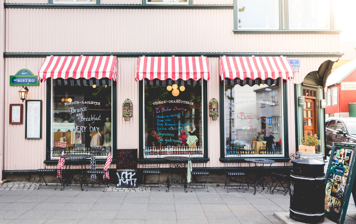 Charming bistro with striped awnings, showcasing a blend of e-commerce and brick-and-mortar retail strategies.