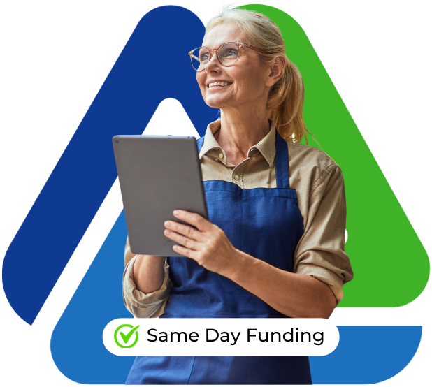 Smiling businesswoman in apron holding a tablet, promoting same day funding for working capital loans.