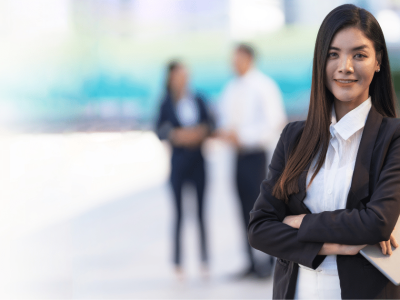 Professional woman in business attire with a tablet, representing expert media consulting for business growth.