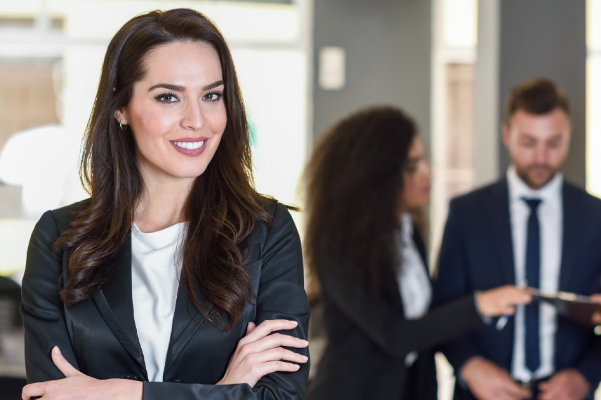 Professional woman in a suit, representing small business loan candidacy and financial success tips.