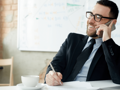 Business professional managing time effectively while on a phone call, emphasizing time management strategies.