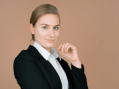 Professional woman in business attire promoting customer satisfaction for business growth and financial success.
