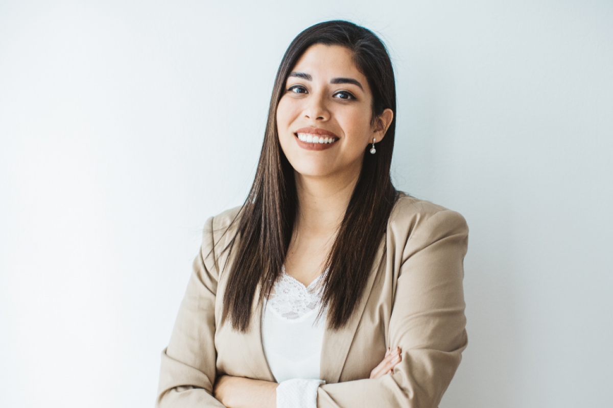 Smiling businesswoman in a blazer, representing entrepreneurship and business success strategies.