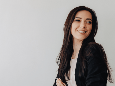 Smiling businesswoman in a blazer, representing effective email marketing strategies for small businesses.