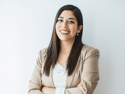 Smiling businesswoman in a blazer, representing entrepreneurship and business success strategies.