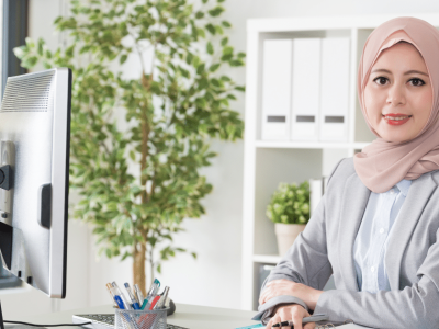 Professional woman in an office setting, highlighting the importance of mobile apps for small business growth and customer engagement.