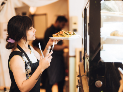 Smiling businesswoman giving a thumbs up in a retail environment, representing small business success and unsecured credit lines.