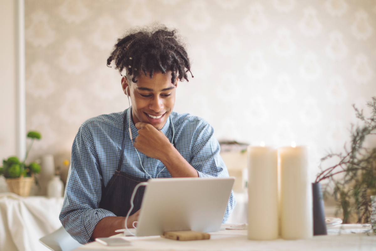 Smiling woman on the phone with a tablet, exploring unsecured business loans for real estate potential.