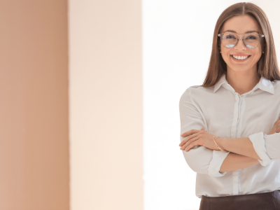 Smiling businesswoman in a professional setting, representing small business empowerment and web solutions.