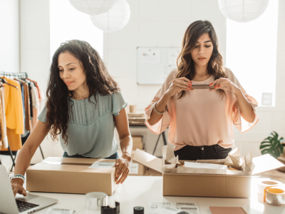 Women entrepreneurs managing business operations, showcasing teamwork and efficiency in a modern workspace.