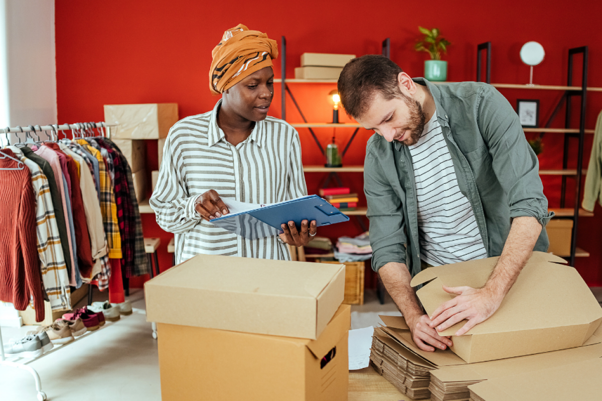 Business owners collaborating on inventory management in a retail space, highlighting flexible business loans for bad credit.