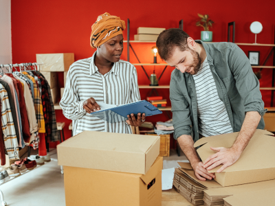 Business owners collaborating on inventory management in a retail space, highlighting flexible business loans for bad credit.