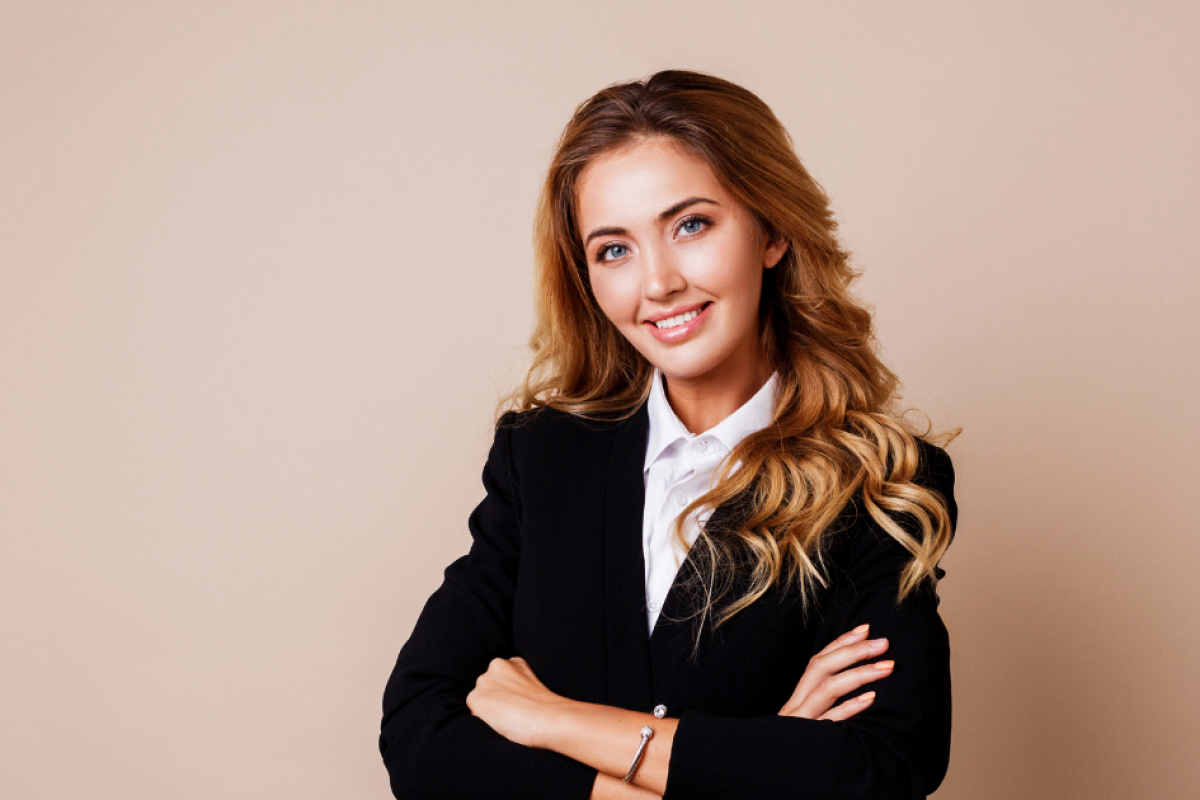 Professional woman smiling in a business suit, representing eCommerce payment gateway solutions for online stores.