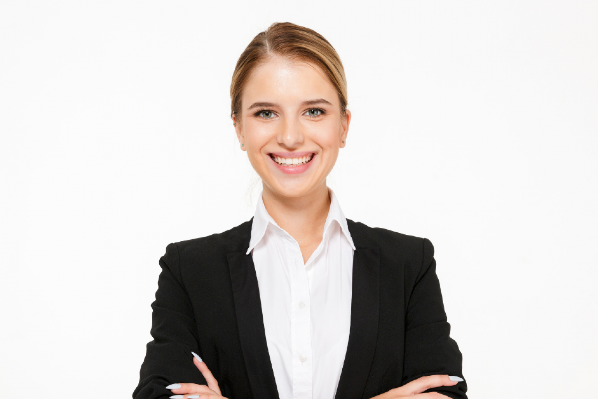 Smiling businesswoman in a suit, representing success strategies for small business growth and customer relationships.