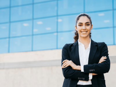 Businesswoman in a suit smiling confidently, representing effective marketing automation strategies for small business success.