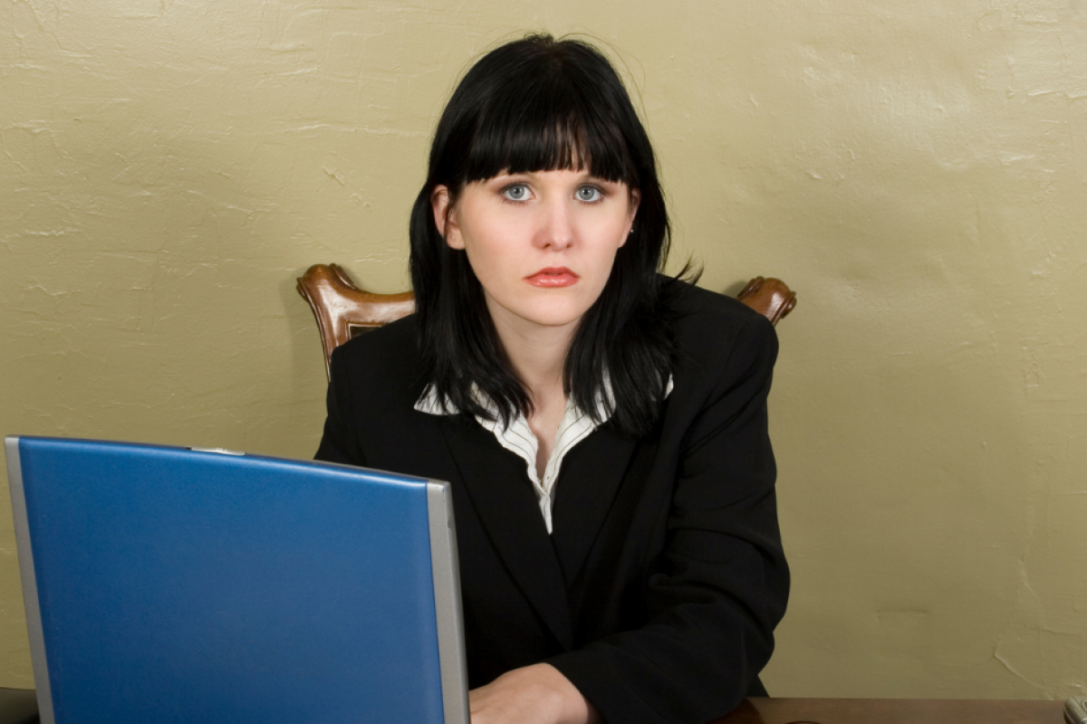 Smiling woman using a tablet in a retail store, exploring holiday loans for small business inventory and staffing needs.