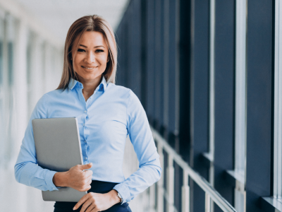 Professional woman holding a laptop, representing mobile marketing strategies for business success and local SEO optimization.