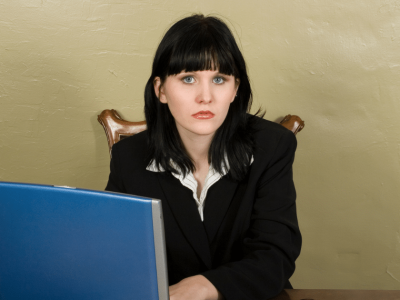 Businesswoman at desk preparing for holiday sales, emphasizing the importance of funding for Black Friday and Cyber Monday.
