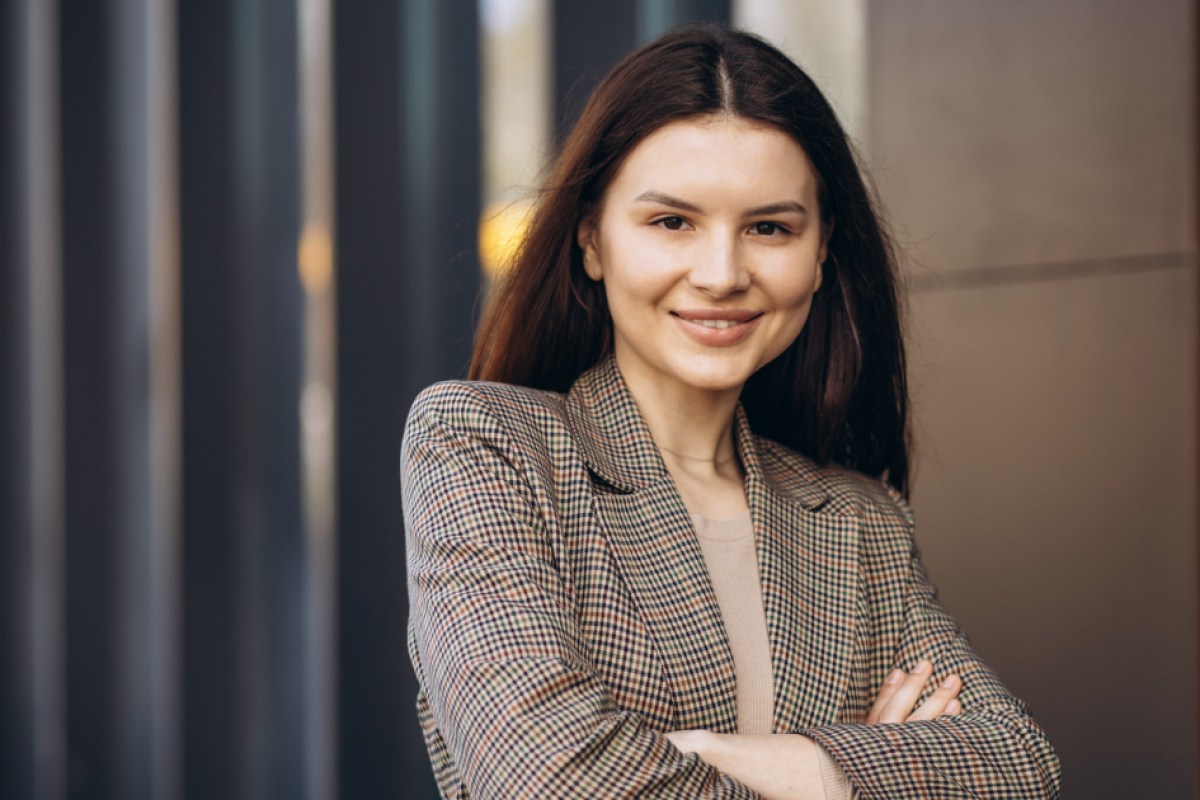 Professional woman smiling in a blazer, representing the restaurant industry's seasonal changes and business strategies.