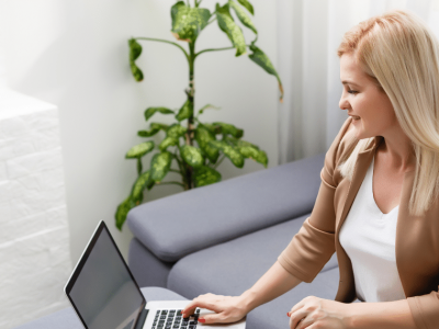 Woman planning retirement on a laptop, emphasizing early savings for financial security and future stability.