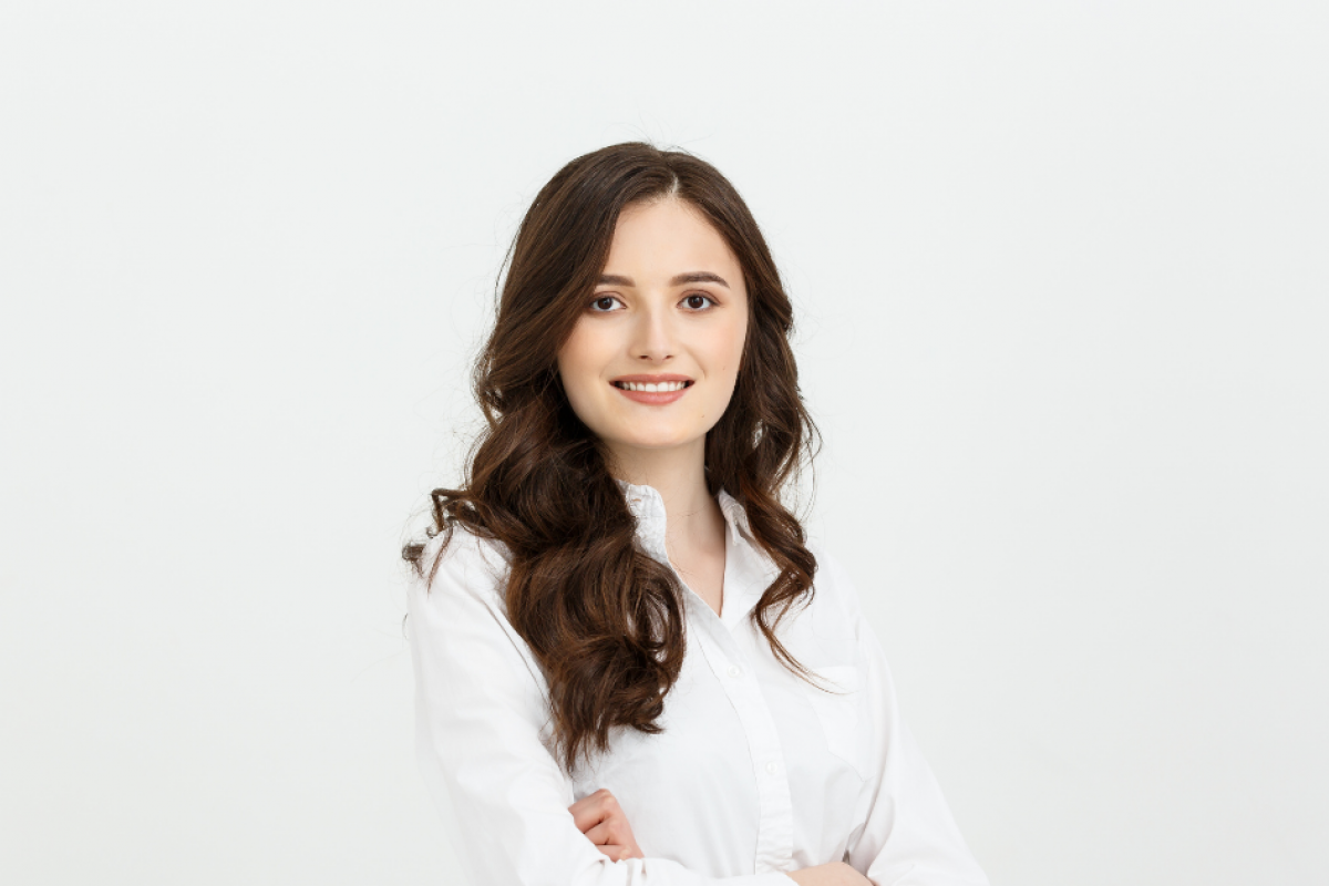 Professional woman in business attire in a modern office, representing small business operations and the Affordable Care Act impacts.