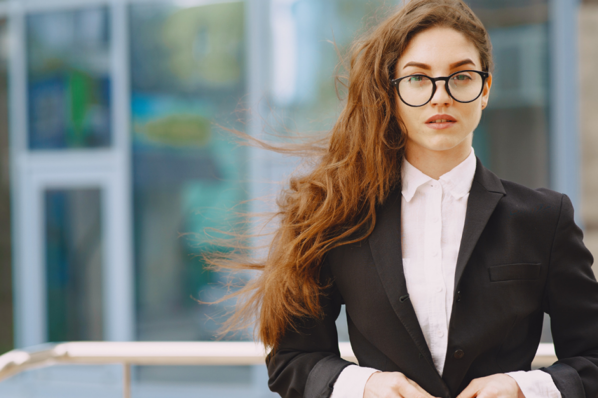 Business professional with long hair in a suit, representing strategies to rebuild bad business credit.