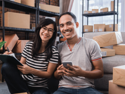 Small business owners planning for success, managing finances, and avoiding pitfalls in a home office setting.