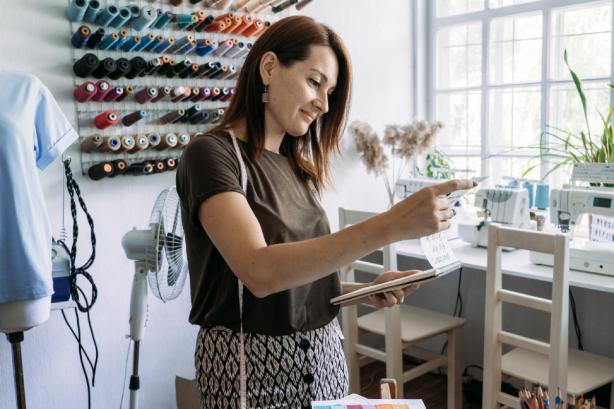 Business owner evaluating financing options in a creative workspace, considering loans and lines of credit for growth.