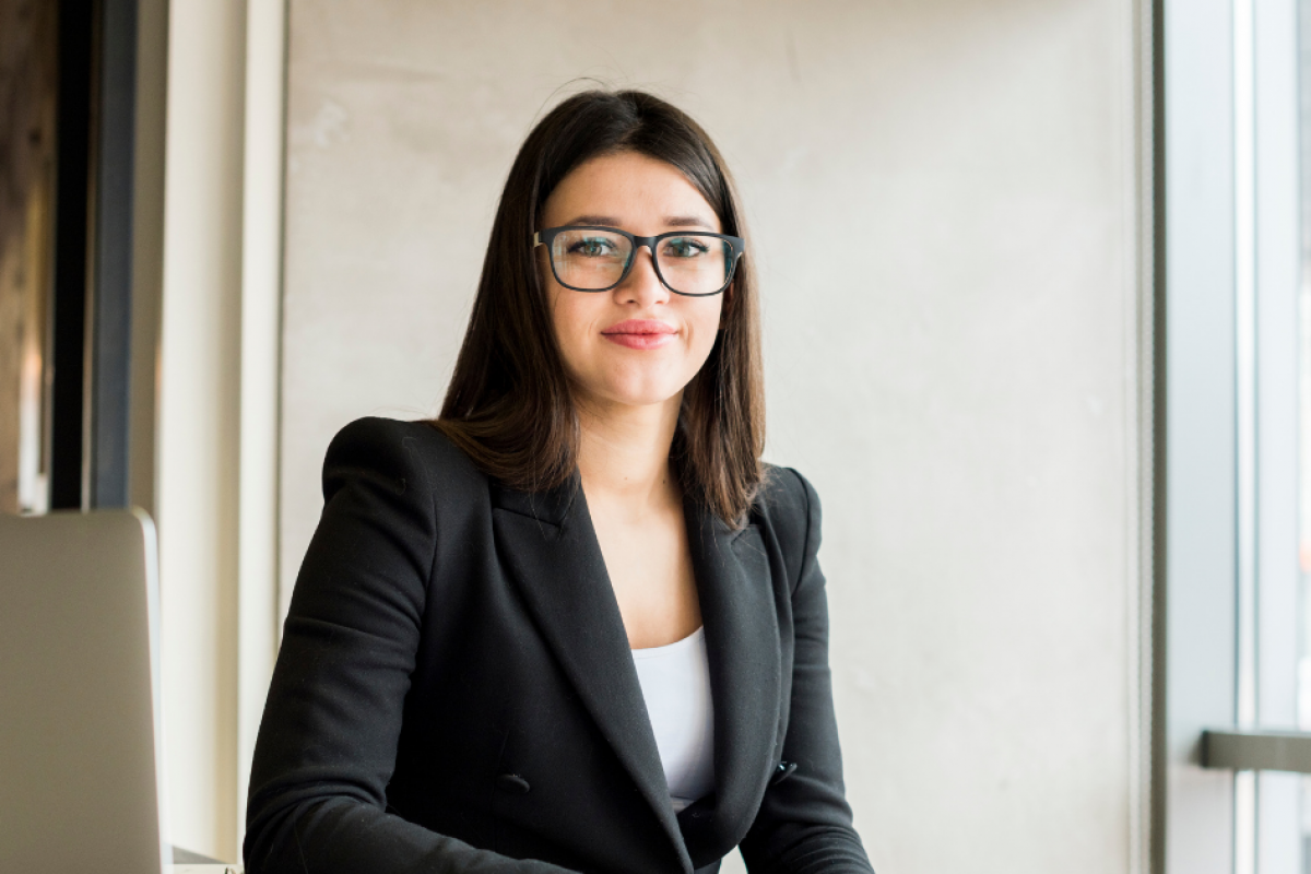 Professional woman in a business suit, representing cost-effective marketing strategies for small businesses.