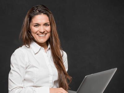 Smiling businesswoman with laptop, exploring financing options for small business success and growth.
