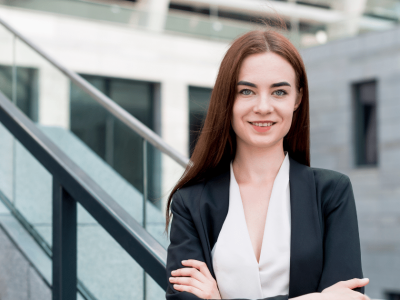 Professional woman smiling confidently outdoors, representing effective strategies for managing negative social media reviews.