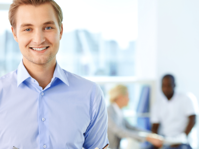 Smiling professional in a business setting, representing effective lead generation and marketing strategies.