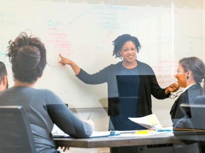 Business meeting discussing financial strategies and merchant cash advances for debt management and growth.