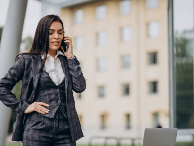 Businesswoman in a suit on the phone, representing strategies for business growth and expansion.