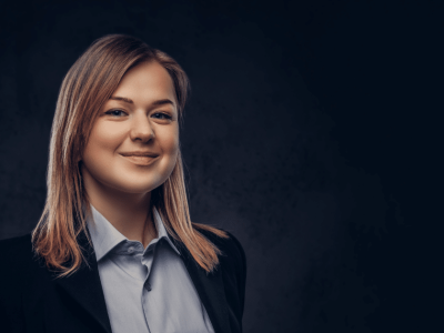 Professional woman smiling, representing small business funding solutions and financial growth opportunities.