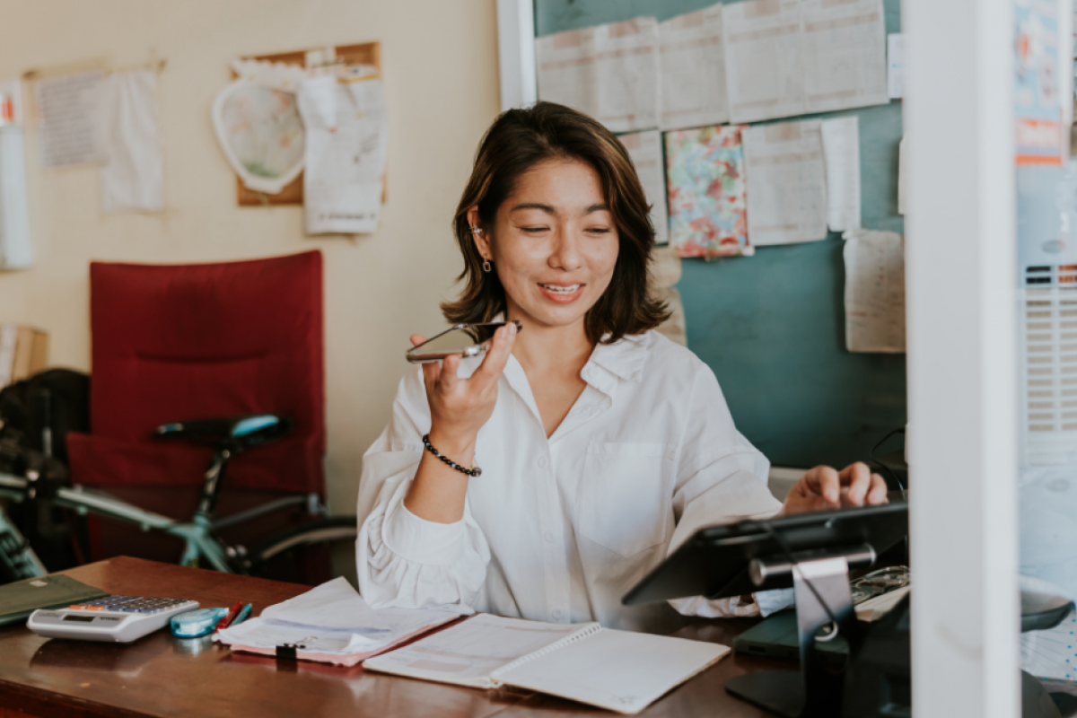 Woman entrepreneur managing her small business, using technology and planning for success in a supportive environment.