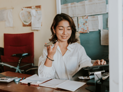 Woman entrepreneur managing her small business, using technology and planning for success in a supportive environment.