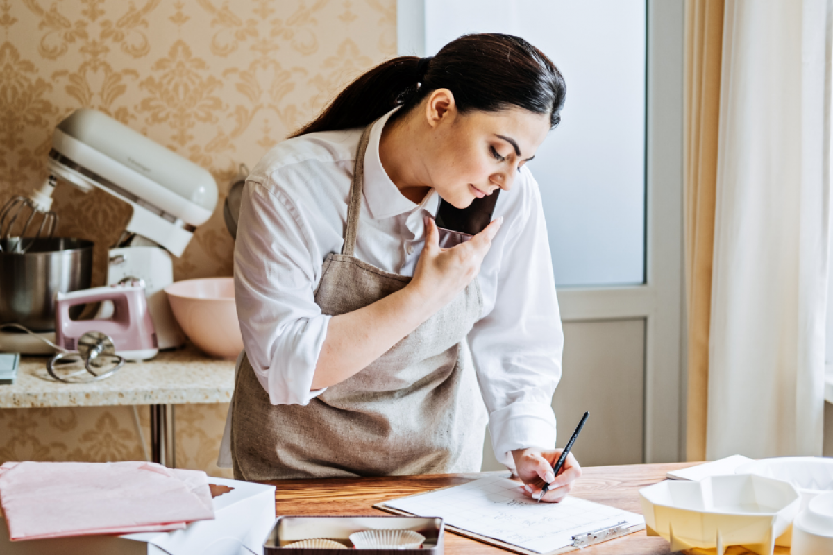 Small business owner using PR strategies to enhance brand awareness and growth in a kitchen setting.