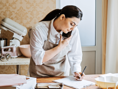 Small business owner using PR strategies to enhance brand awareness and growth in a kitchen setting.