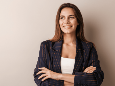 Smiling businesswoman in a striped blazer promoting a paperless office transition for small businesses.