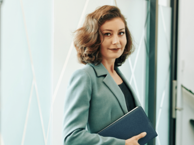 Professional woman holding a notebook, representing strategies for boosting sales and engaging impulse buyers.