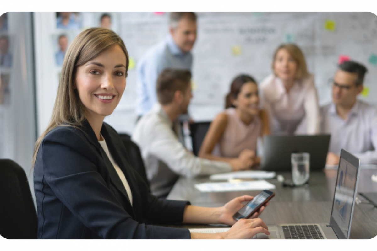 Business professional using a smartphone in a meeting, highlighting strategic credit card benefits for growth.