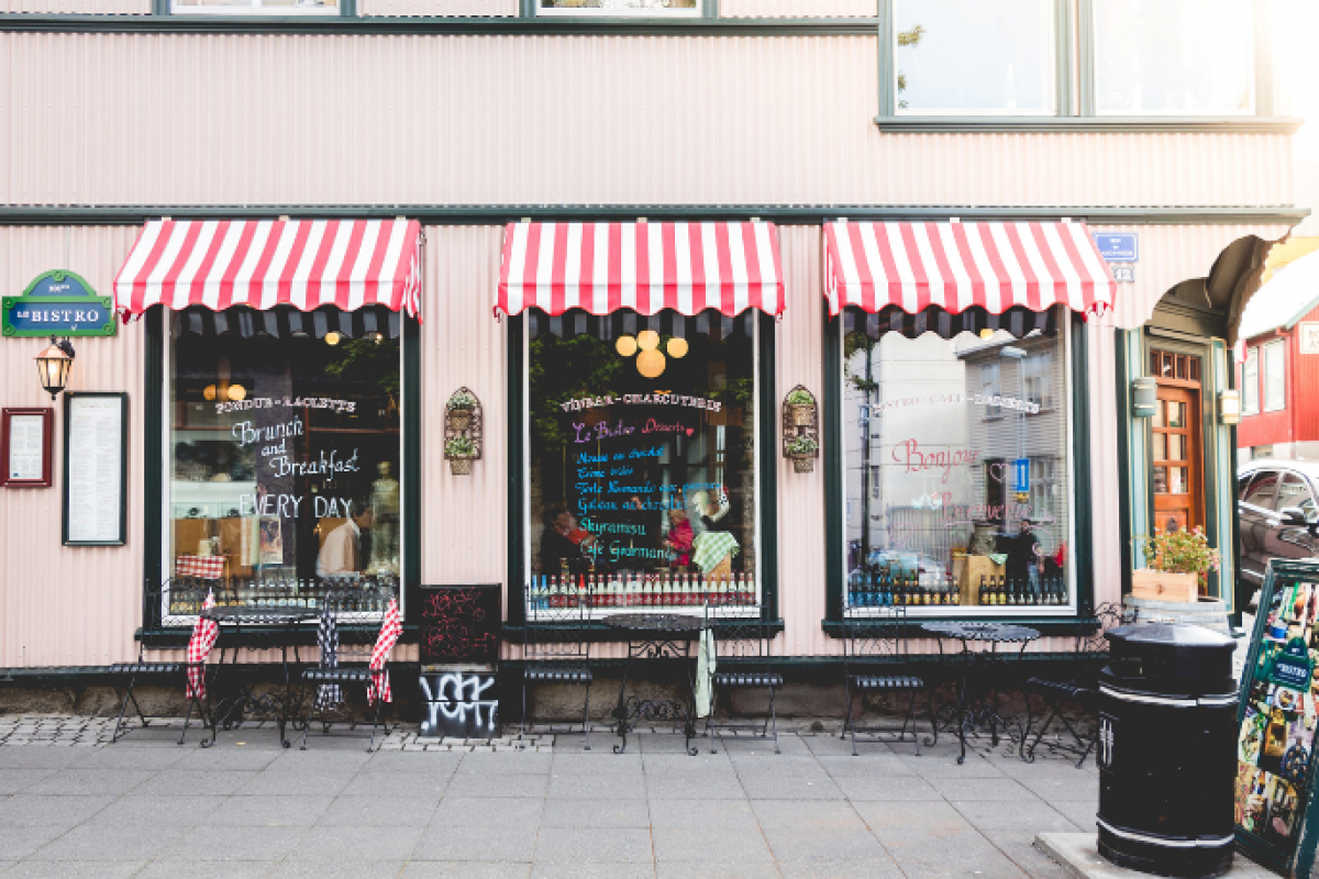 Charming bistro with striped awnings, showcasing a blend of e-commerce and brick-and-mortar retail strategies.