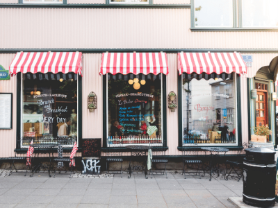 Charming bistro with striped awnings, showcasing a blend of e-commerce and brick-and-mortar retail strategies.