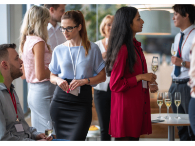 Networking event with professionals engaging in conversation, showcasing effective small business networking strategies.