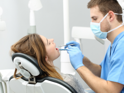Dentist providing care to a patient in a dental office, highlighting flexible financial solutions for dental practices.