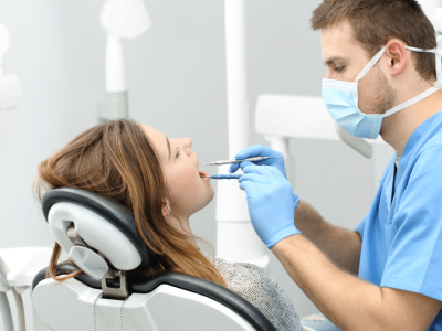 Dentist providing care to a patient in a dental office, highlighting flexible financial solutions for dental practices.