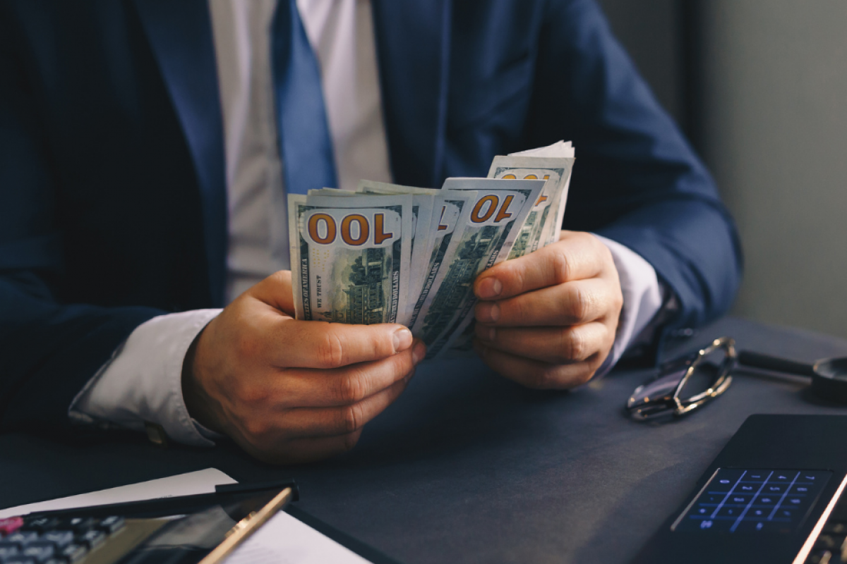 Businessman counting cash for working capital loans to support small business growth and financial stability.