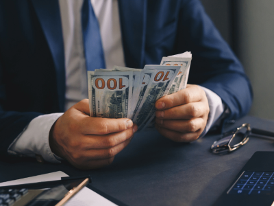 Businessman counting cash for working capital loans to support small business growth and financial stability.